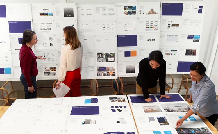 The office working on a large guidelines book